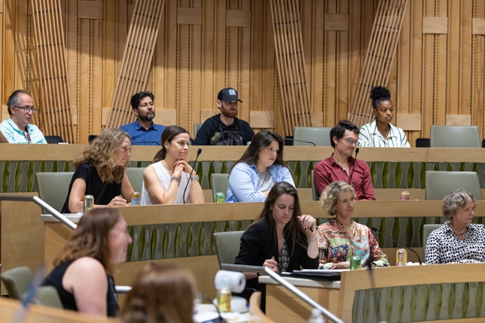 Audiencememberslookingforwardlisteningtoresponsesfrompanelists