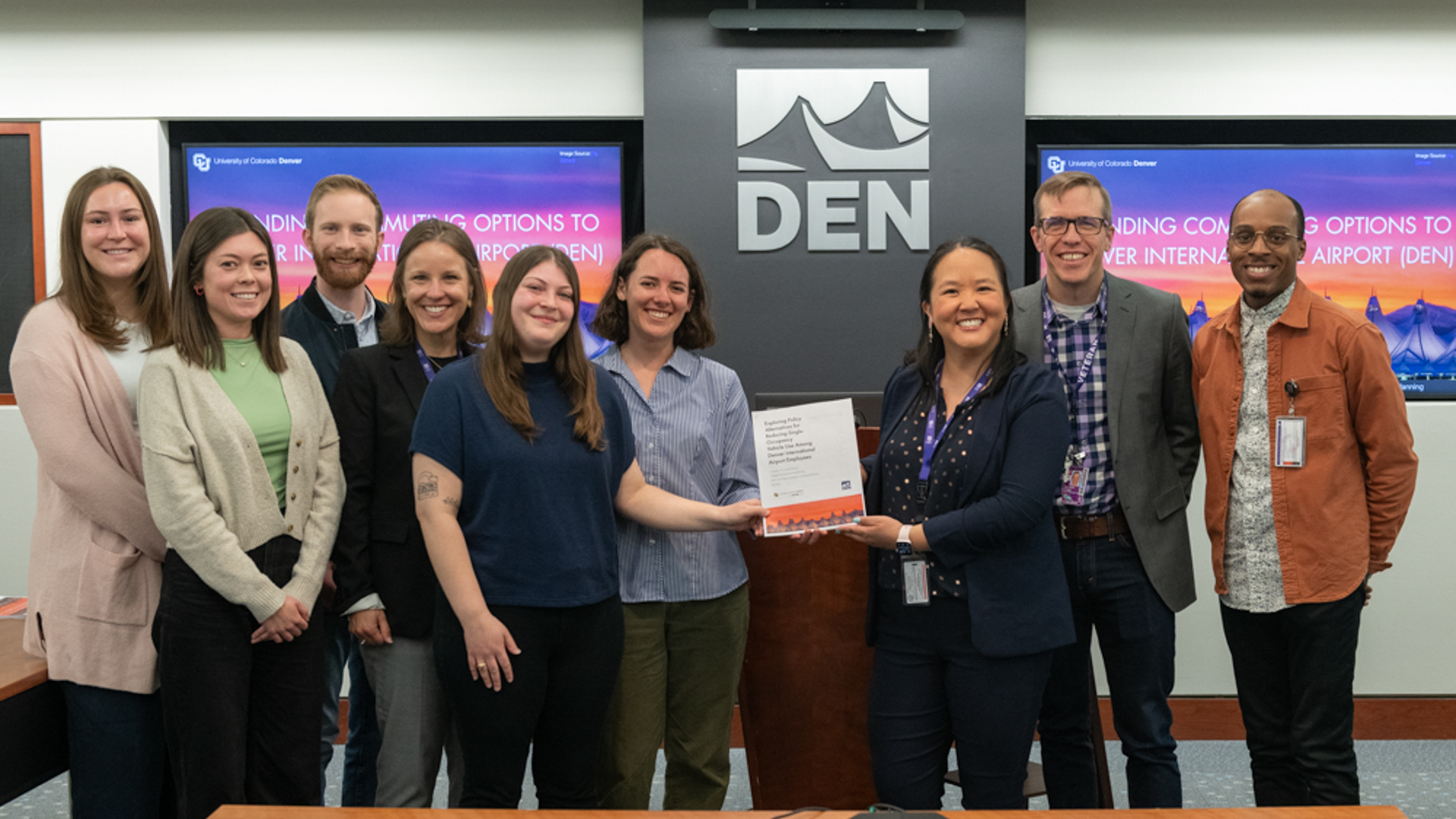 Students joined DEN staff at the airport holding their final presentation.