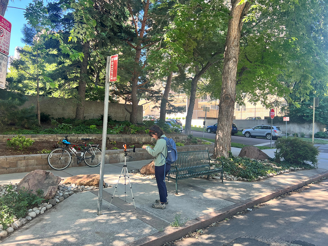 A research assistant collects heat stress data at a bus stop as part of Austin Troy’s NSF-funded project “Modeling extreme heat at transit stops and its implications for equity.”
