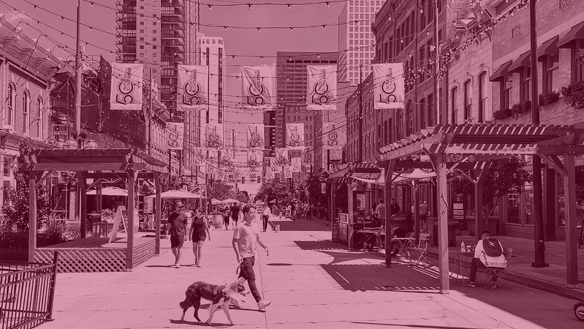 A man walking his dog across Larimer Square with a pink overlay.
