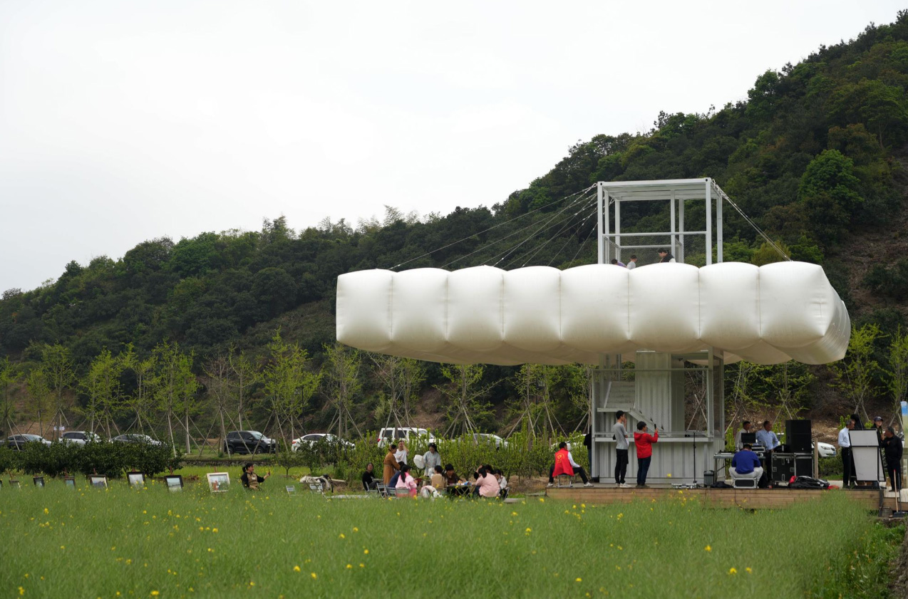Full view of the On the Clouds installation in a field.