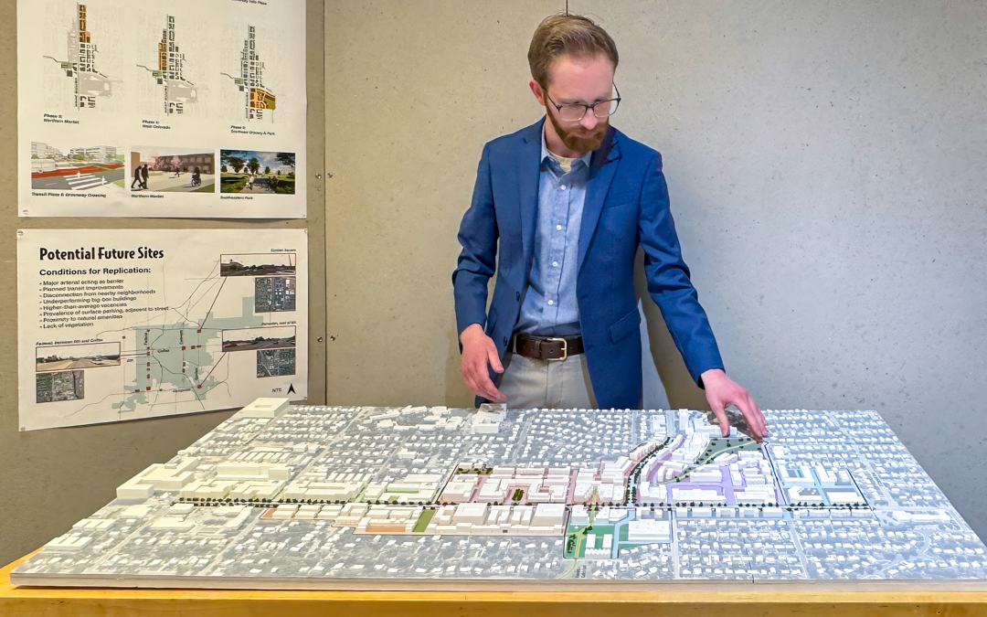 A student shows a large topographical model.