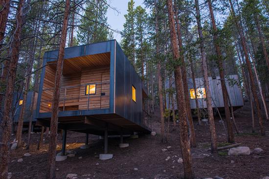 steel-clad cabin at dusk in lodgepole pines