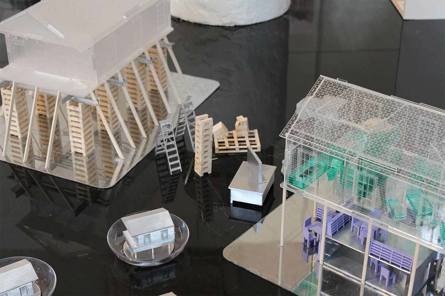 Two models placed next to each other with small model ladders set up in the middle.