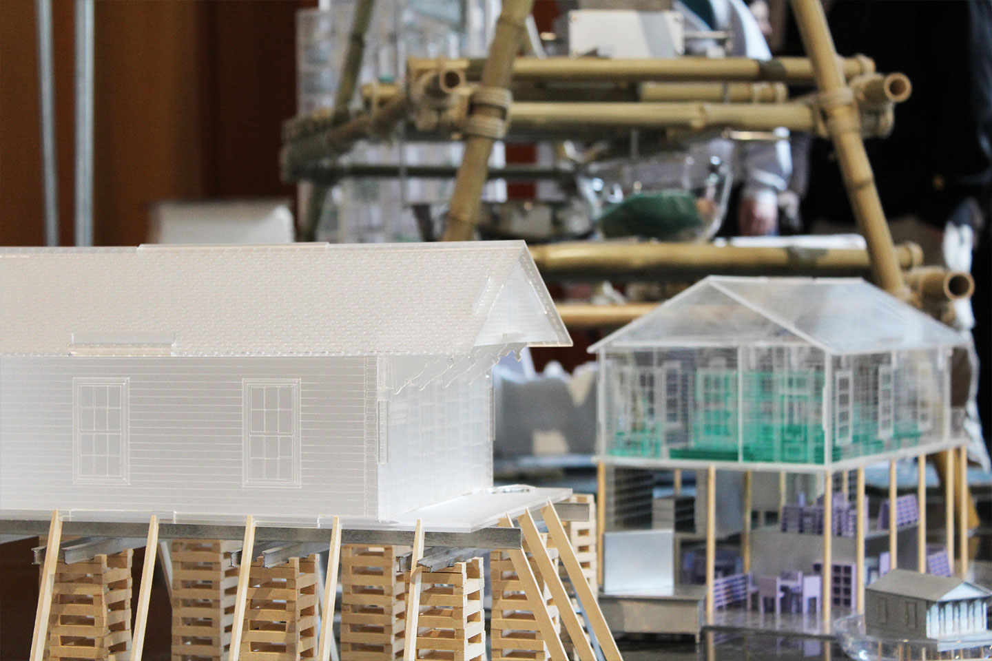 Two models placed next to each other, one with a facade and the other showing the interior.