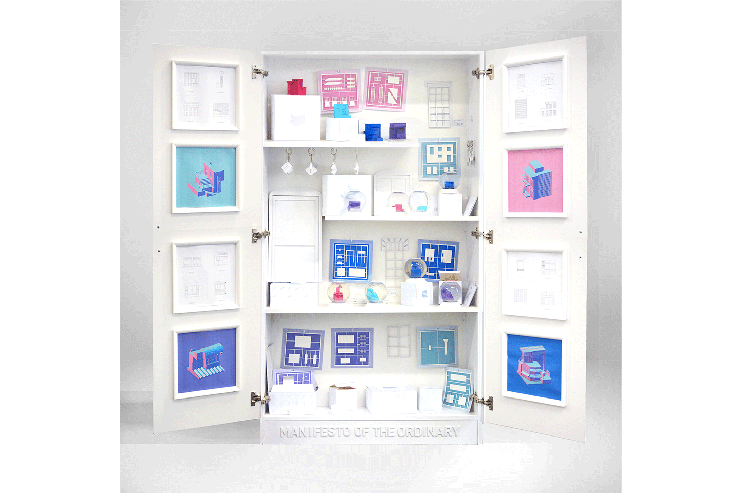 A model showing interior design of an office wall featuring renderings of buildings and the words Manifesto of the Ordinary.