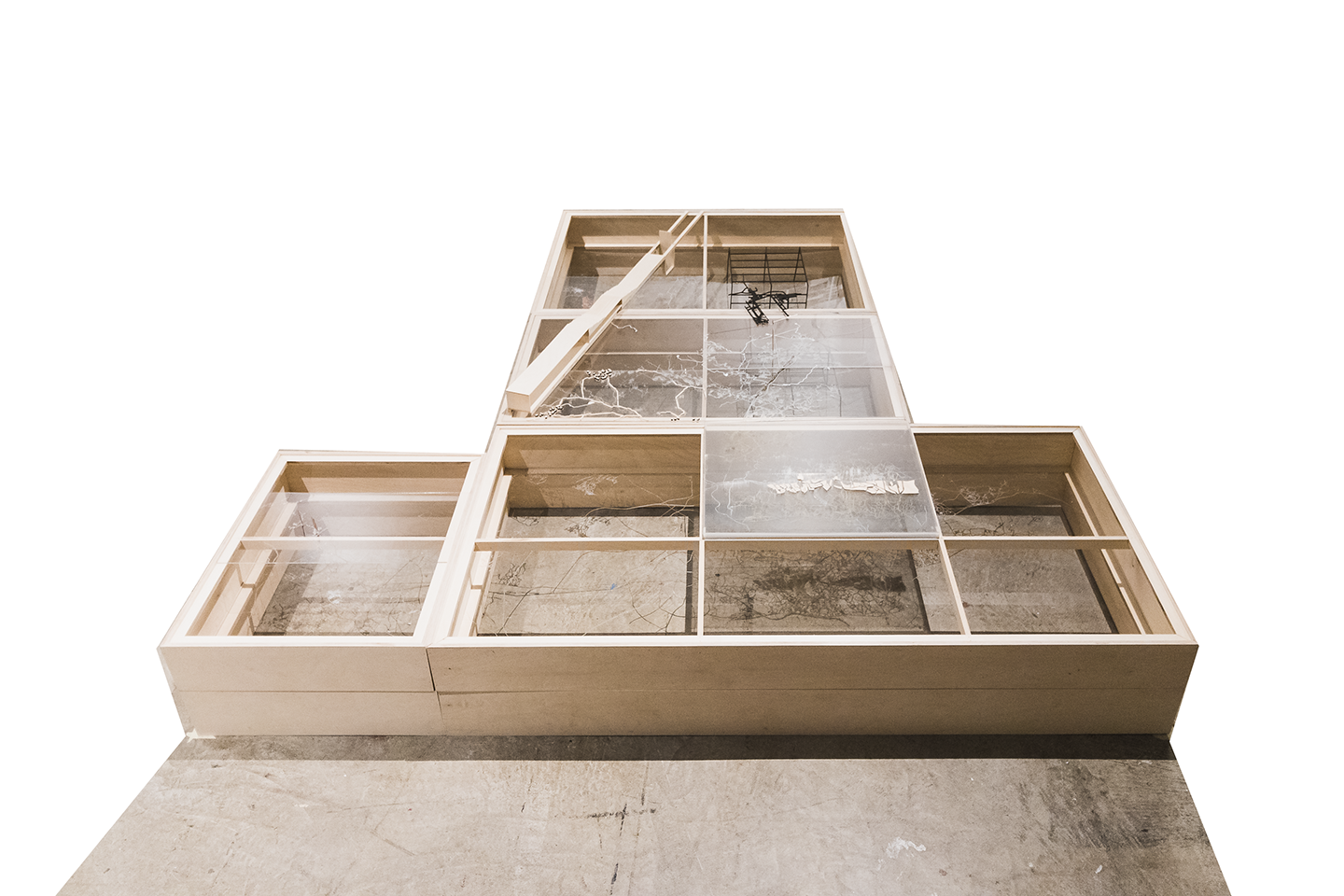 A wooden shadowbox-like site model with windows featuring different textures.