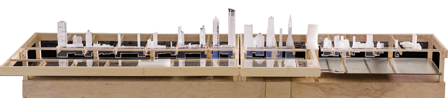 A long site model of Manhattan's 42nd Street on a wooden table.