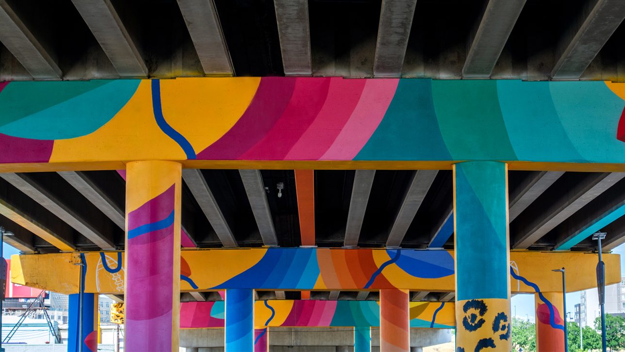Brightly colored artwork painted under the Sun Valley Colfax Viaduct.