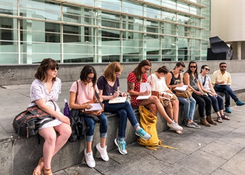students sketching in notebooks in Barcelona