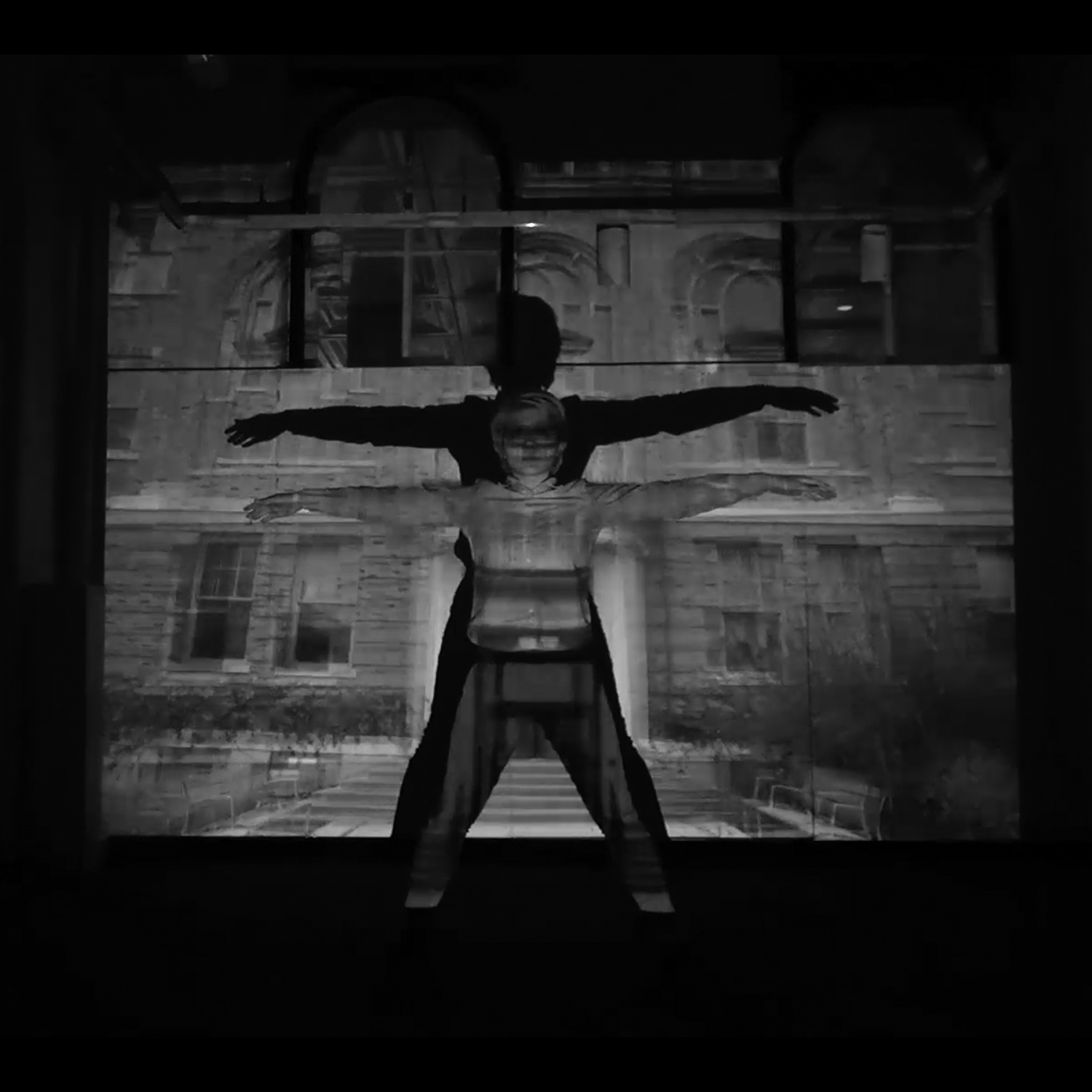 Woman standing in front of a projection in black and white.