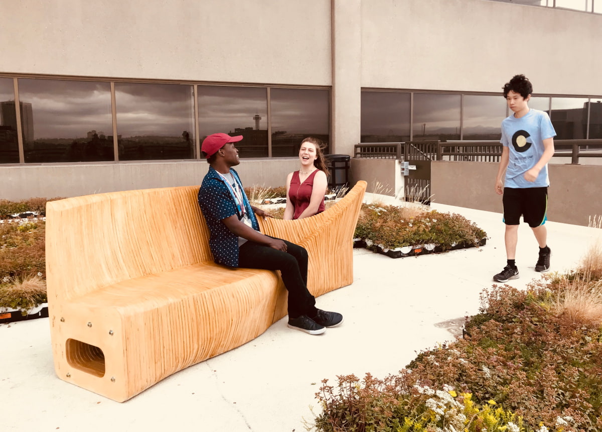 students sitting on some patio furniture