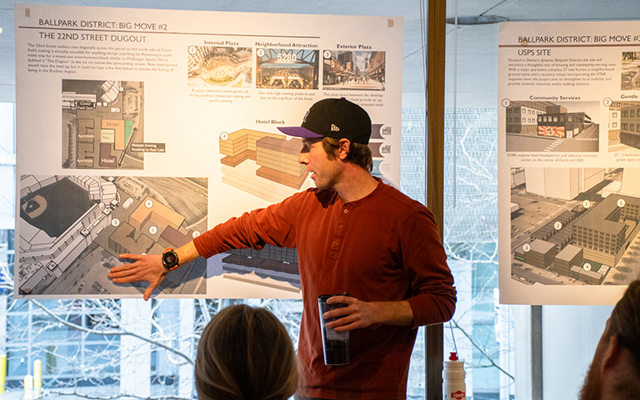 Student postings to a poster taped to a window during a urban planning studio presentation.