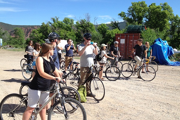 A group of students on bikes for a tour of a worksite
