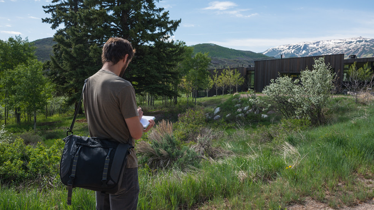 Student sketching with a mountain in the background in Aspen.