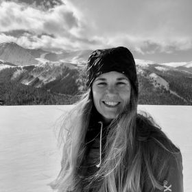 Maddie Fulmer wearing a beanie and standing in the snow.