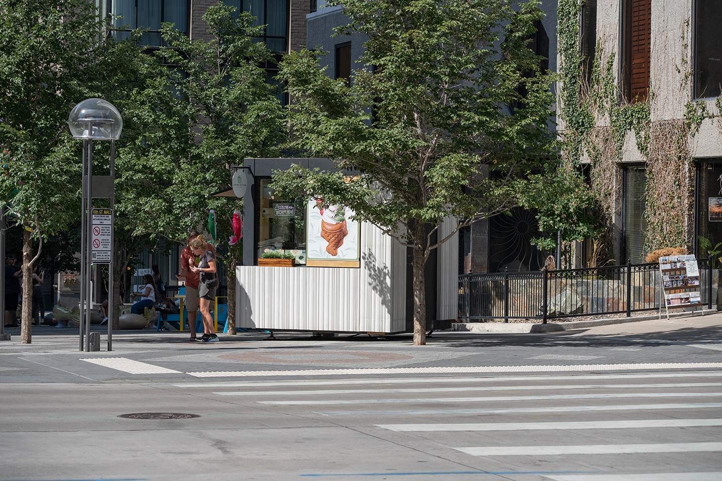 A kiosk matcha ice cream vendor with customers.
