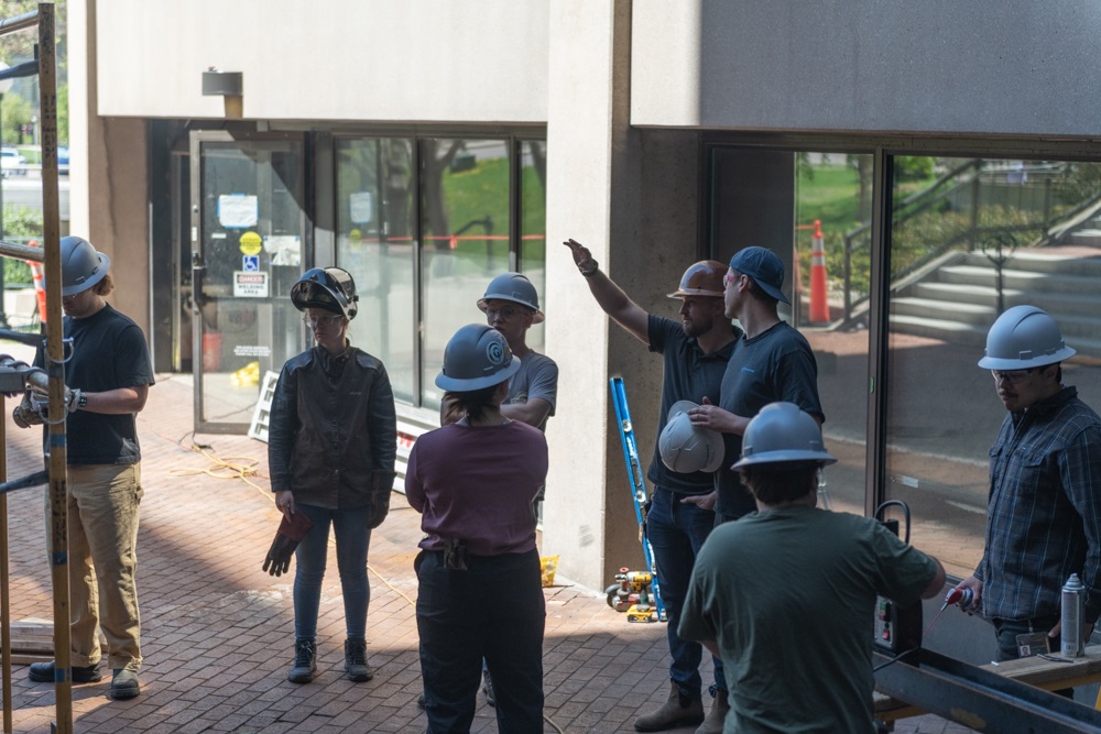 Students and faculty working together on early stages of the kiosk's fabrication.