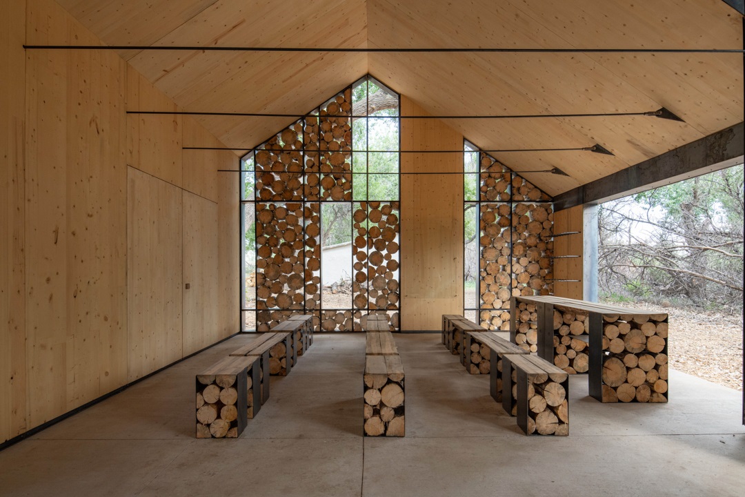 The interior of the Aiken Audubon Research Outpost looking at the seating and a long table.