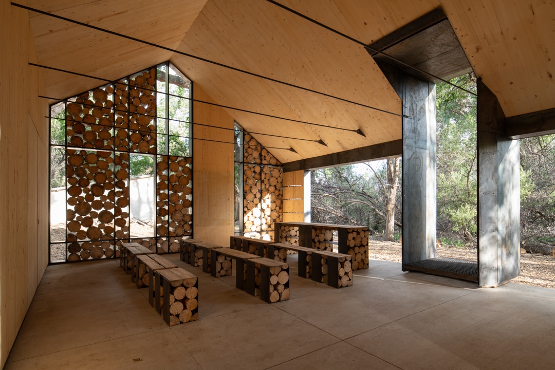 The interior of the Aiken Audubon Research Outpost looking at the seating and a long table.
