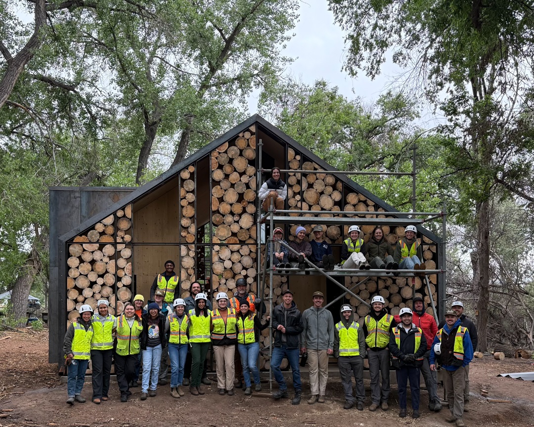 A group photo of the 2025 ColoradoBuildingWorkshop cohort standing in front of the Aiken Audubon Research Outpost.