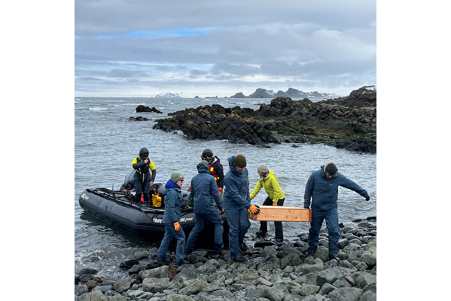 The ColoradoBuildingWorkshop and BeSpoke teams unloading a  zodiac carrying building material.