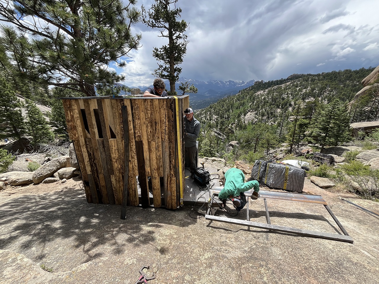 The team constructing the privy overlooking the mountains.